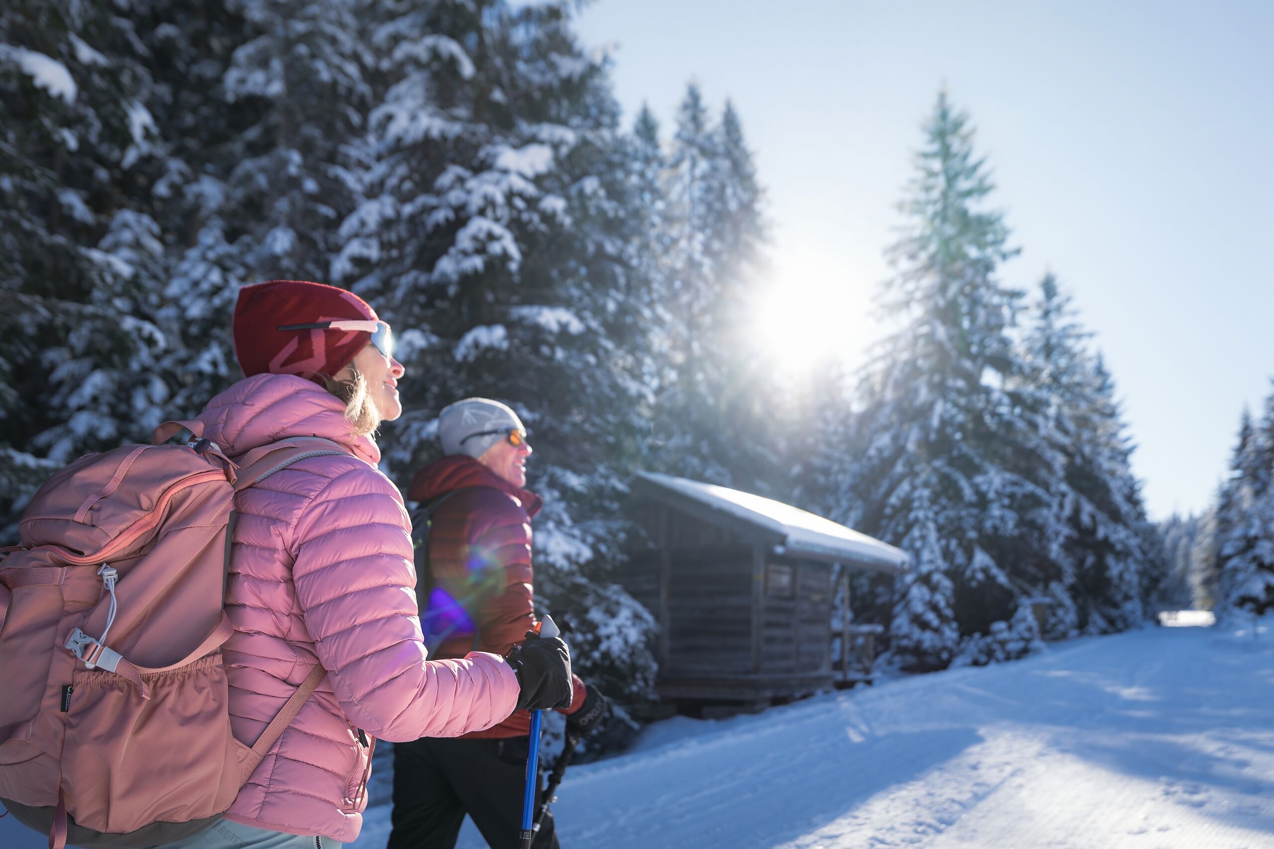 Winterwandern in der Region Seefeld_Mann und Frau wandern im Fludertal_Aufnahme von hinten gegen die Sonne