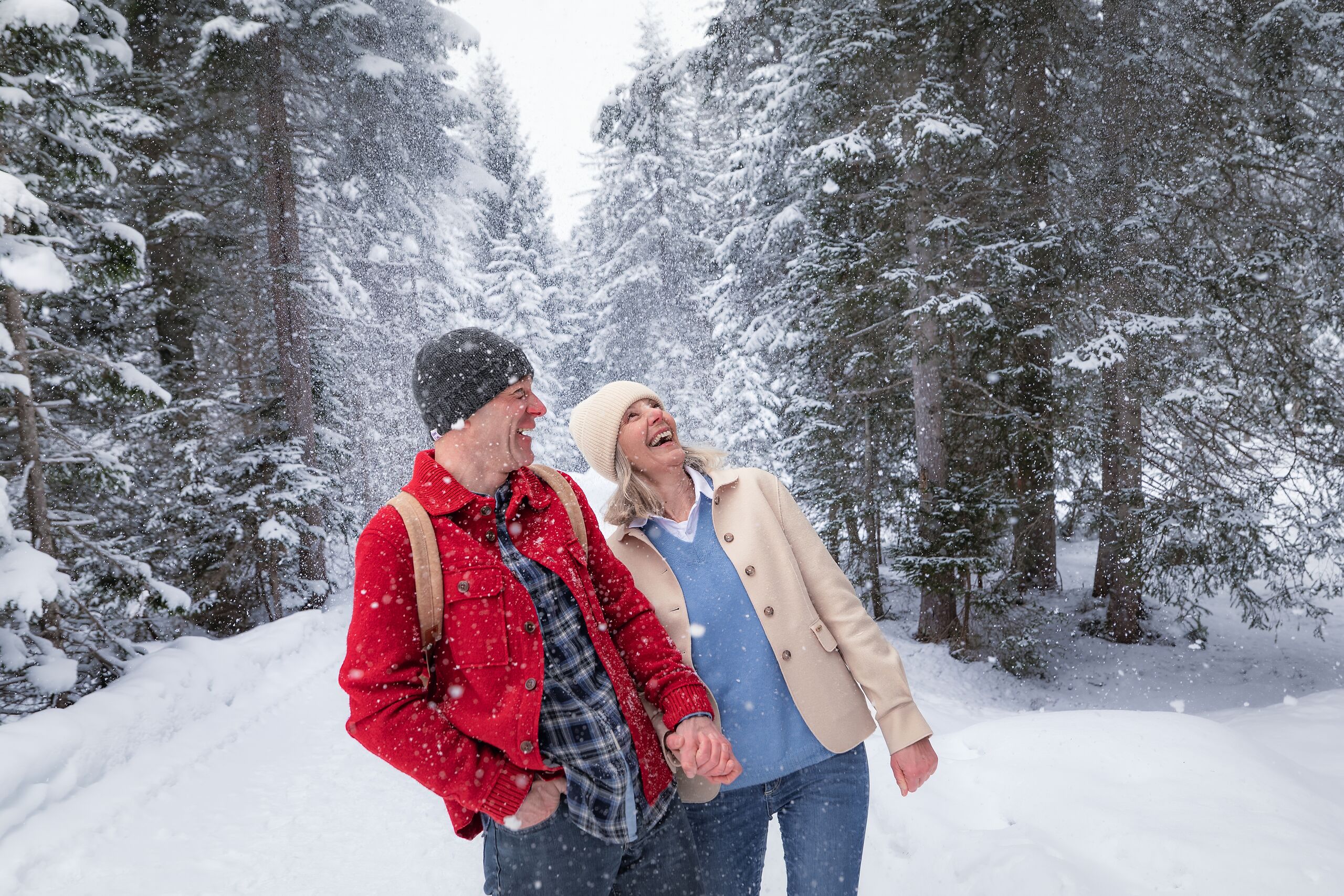 Winterwandern im Wildmoos_Paar lacht mit Schnee der hinunter fällt